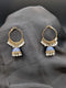 Gold-toned Jhumka hoop earrings featuring royal blue enamel bell pendants and a delicate white pearl fringe on a dark grey background.
