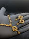 Handheld 24k gold plated necklace set featuring a peacock and crescent moon pendant with silver accents and matching earrings.