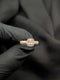 Gold-tone statement ring with an all-clear rectangular baguette center stone accented by four matching round brilliant crystals.