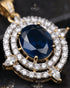 Close-up of sapphire blue centerstone and AD stone halo on Jadau pendant - Jewels by Sarah 22K gold polish