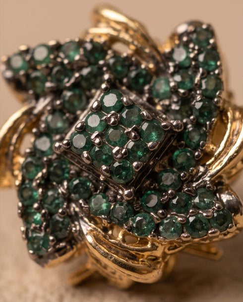 Close up of emerald green stone floral stud earring design detail