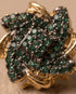 Close up of emerald green stone floral stud earring design detail
