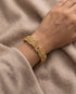 Gold plated South Indian floral bangle worn on wrist
