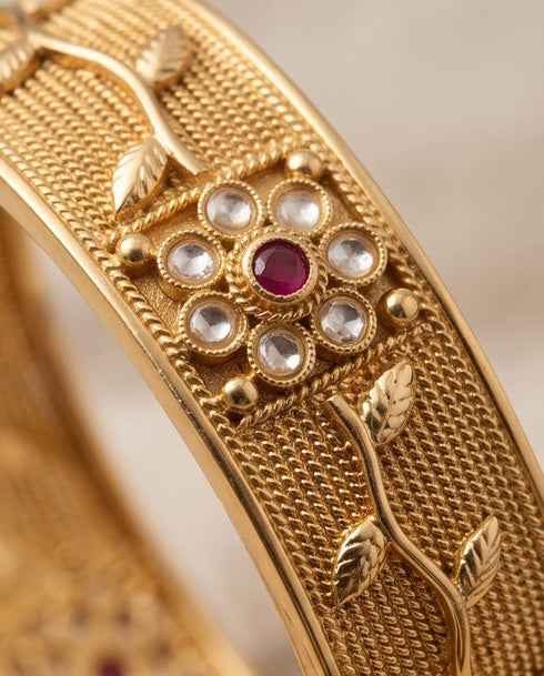 Close up of South Indian bangle vine leaf design with ruby stone detail