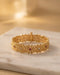South Indian gold plated floral bangle with ruby and white stones on marble