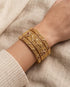 South Indian gold plated bangle set worn on wrist stacked together