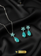 Mint green floral zircon pendant set with teardrop earrings on black background.