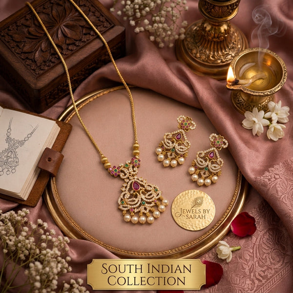 "South Indian temple jewelry set with kemp stone necklace and matching pearl drop earrings displayed on gold tray"